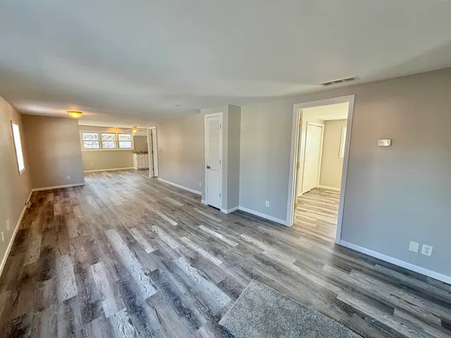 a view of a room with wooden floor and window