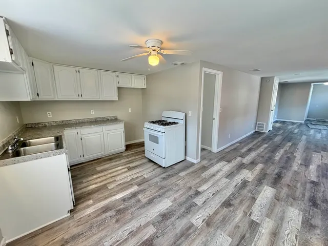 a view of a room with wooden floor and a window
