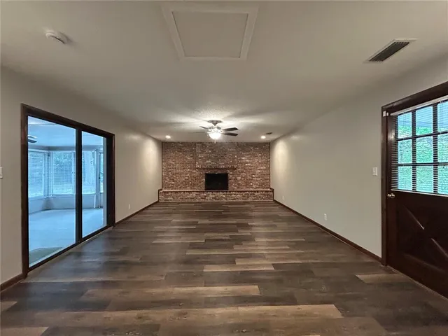 a view of a livingroom with wooden floor and a ceiling fan