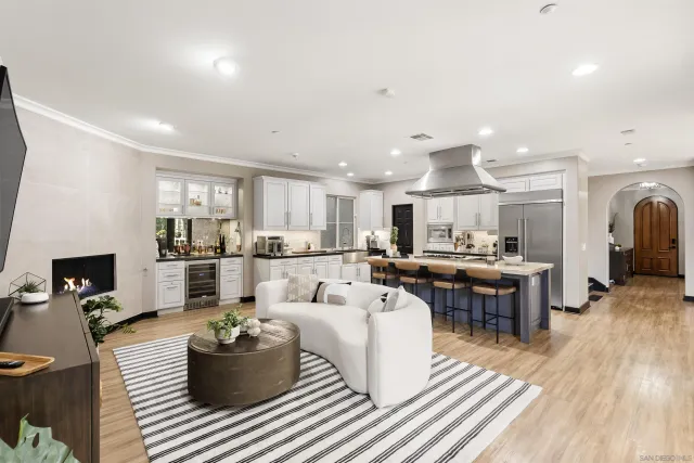 a living room with lots of furniture and kitchen view