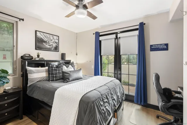 a bedroom with a bed a couch and a window