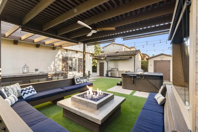 a view of a patio with couches table and chairs with wooden floor