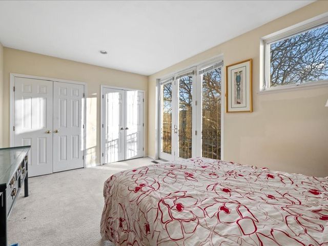 a bedroom with a bed and large window