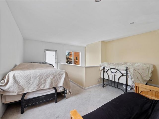 a bathroom with a granite countertop sink a toilet a mirror a bathtub and shower