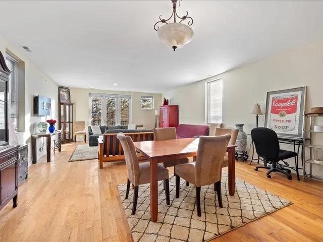 a living room with furniture rug and a large window