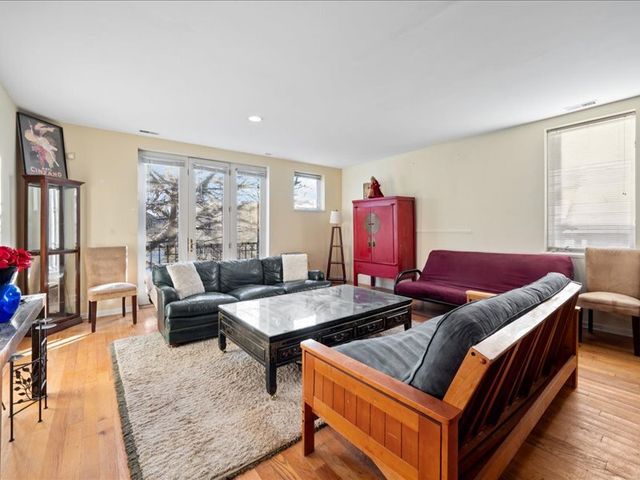 a dining room with a wooden table and chairs
