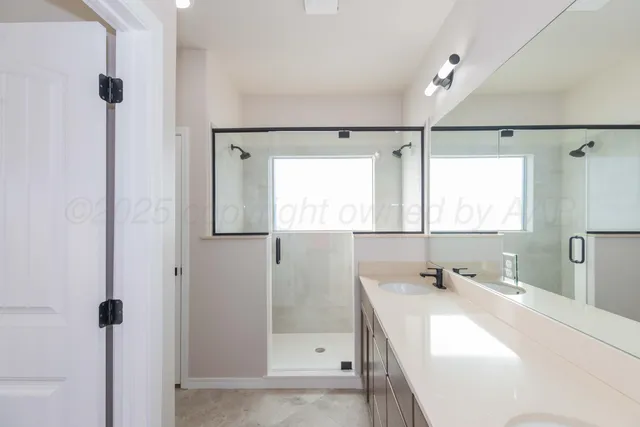 a bathroom with a bathtub shower sink vanity and a mirror