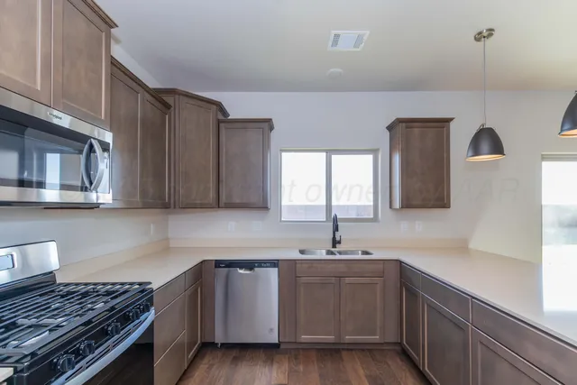 a kitchen with sink and cabinets
