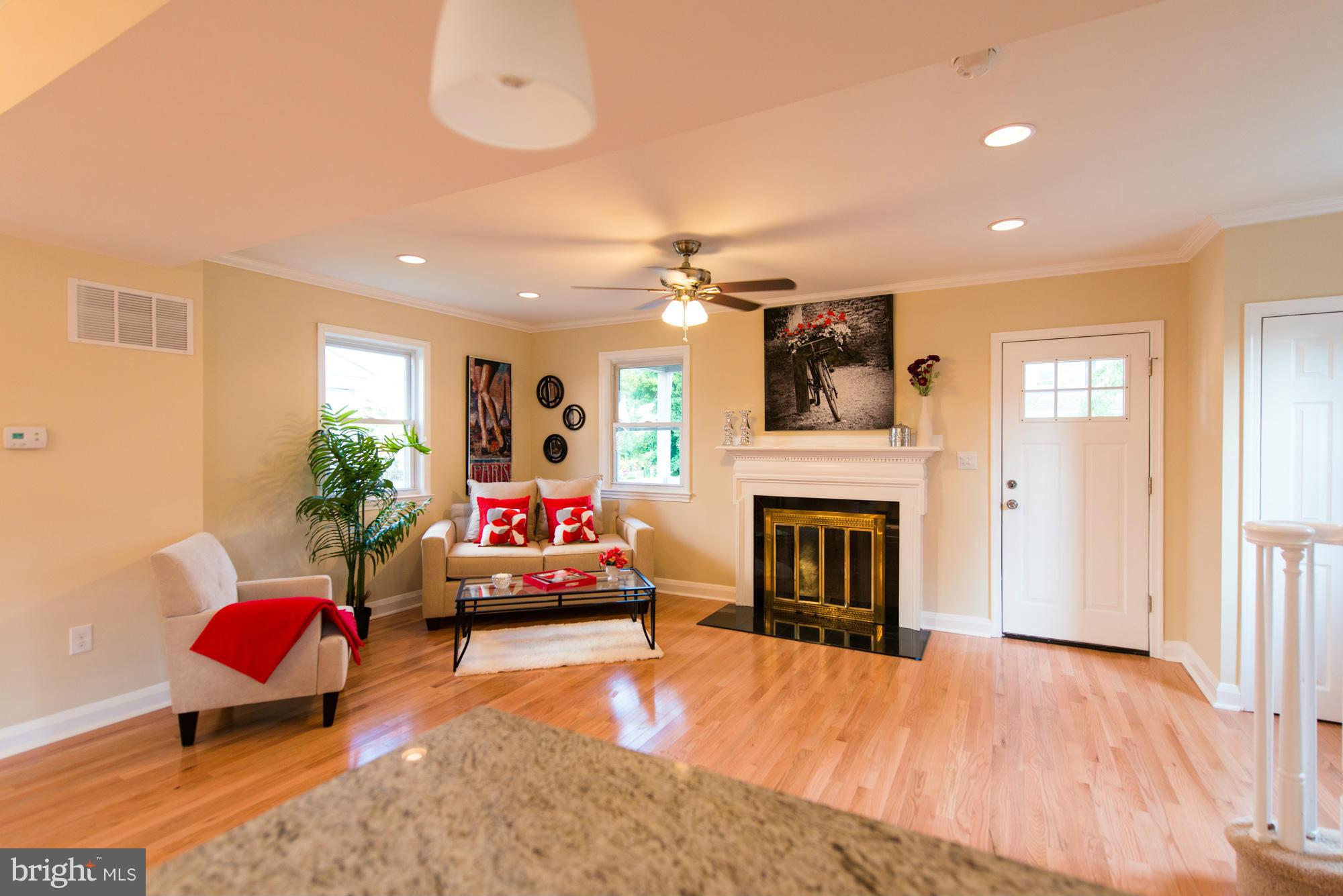 6812 Dunhill Road Baltimore, MD 21222 - Photo 1 of 30 a living room with furniture and a fireplace