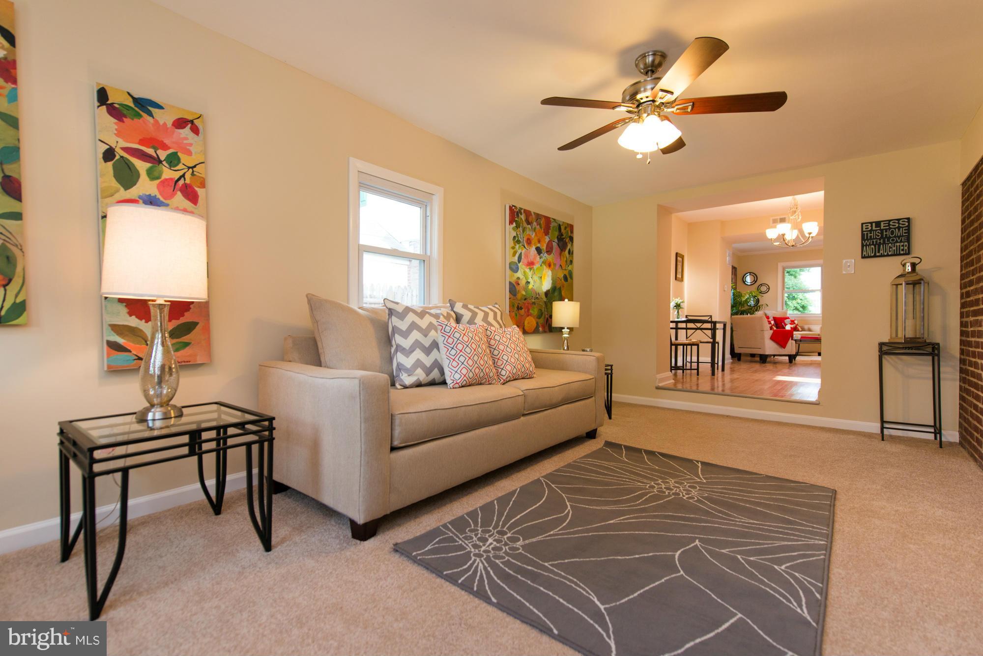 6812 Dunhill Road Baltimore, MD 21222 - Photo 14 of 30 a living room with furniture and a chandelier