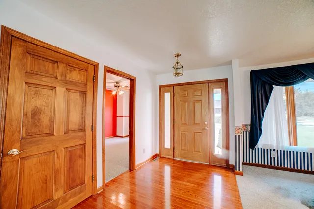a view of a hallway with window and stairs