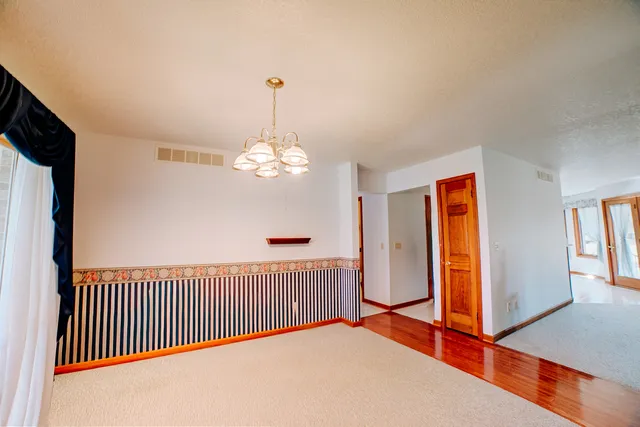 a kitchen with stainless steel appliances granite countertop a refrigerator and a stove