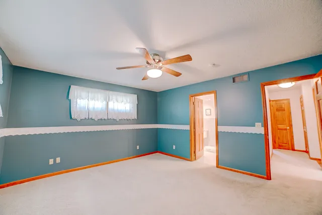a bathroom with a shower curtain and a window