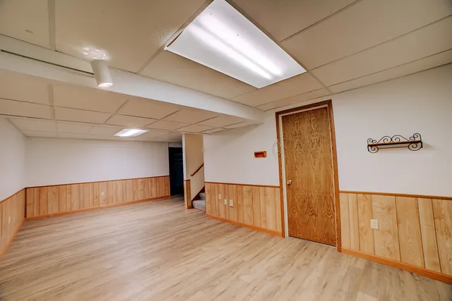 a storage room with wooden floor and furniture
