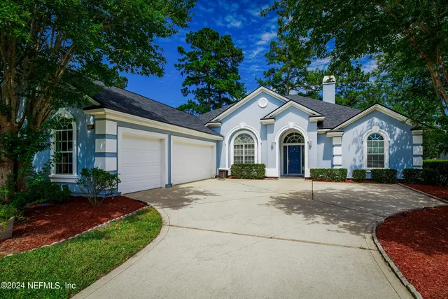 a view of a house with a yard and garage