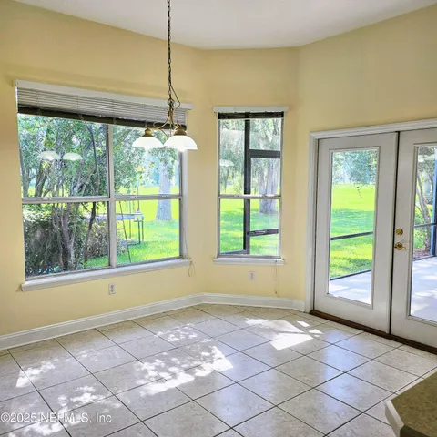 a view of a room that has a window and a ceiling fan
