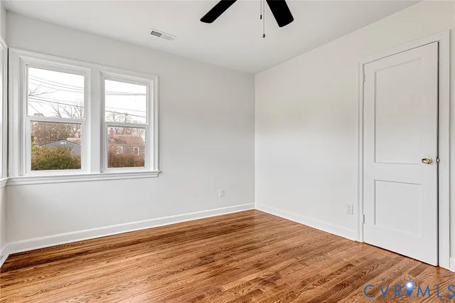 wooden floor in an empty room with a window
