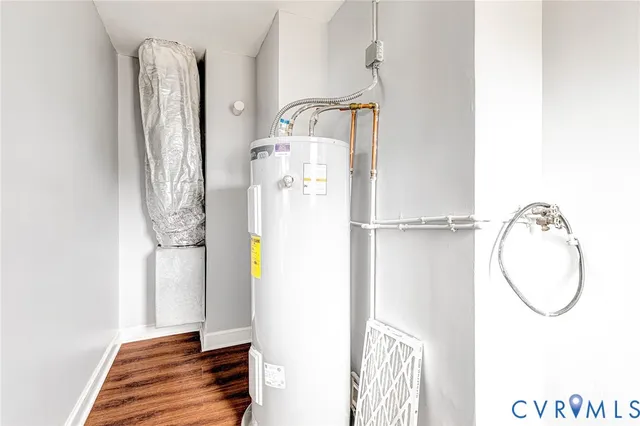 an empty room with wooden floor and a window