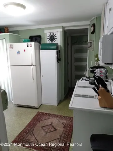 a white refrigerator freezer sitting inside of a kitchen