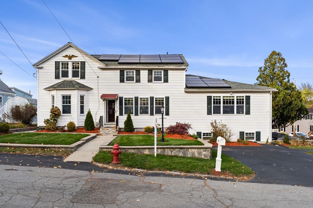 60 Florence Street Lowell, MA 01852 - Photo 1 of 42 a front view of a house with a yard