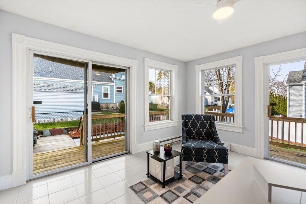 60 Florence Street Lowell, MA 01852 - Photo 24 of 42 a living room with furniture and a floor to ceiling window