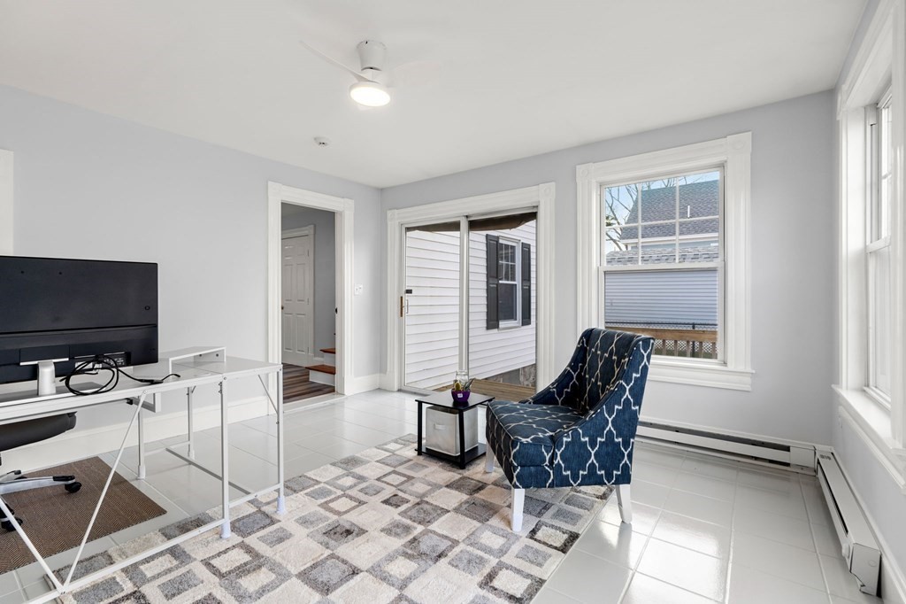 60 Florence Street Lowell, MA 01852 - Photo 25 of 42 a living room with furniture and a flat screen tv