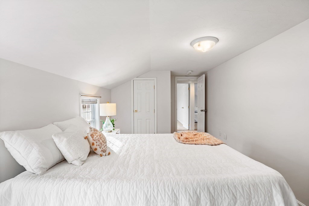 60 Florence Street Lowell, MA 01852 - Photo 27 of 42 a bedroom with a bed and a lamp