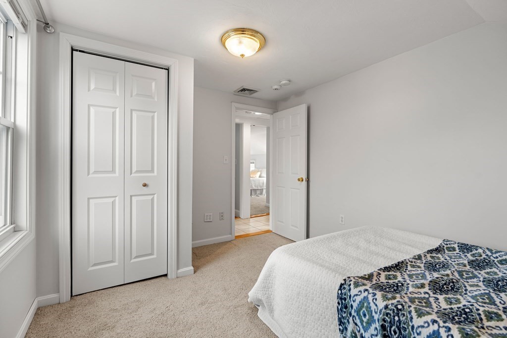 60 Florence Street Lowell, MA 01852 - Photo 29 of 42 a bedroom with a bed and a window