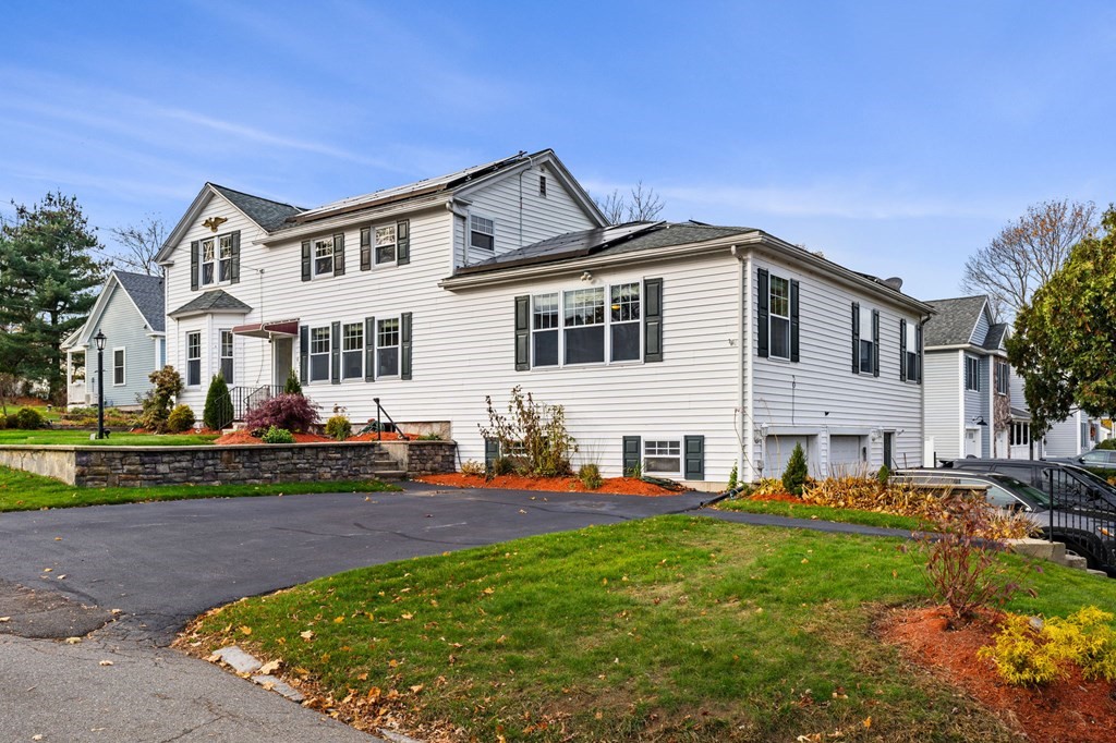 60 Florence Street Lowell, MA 01852 - Photo 3 of 42 a front view of a house with a yard