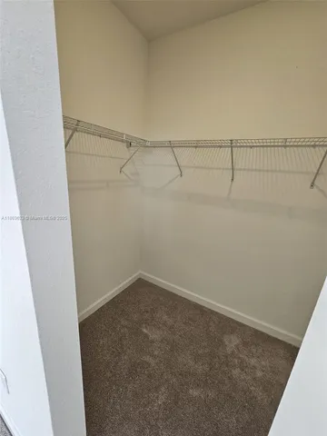 a view of a hallway with washer and dryer