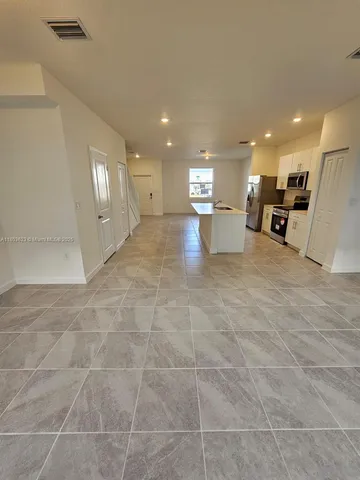 a view of a kitchen with a sink and cabinets