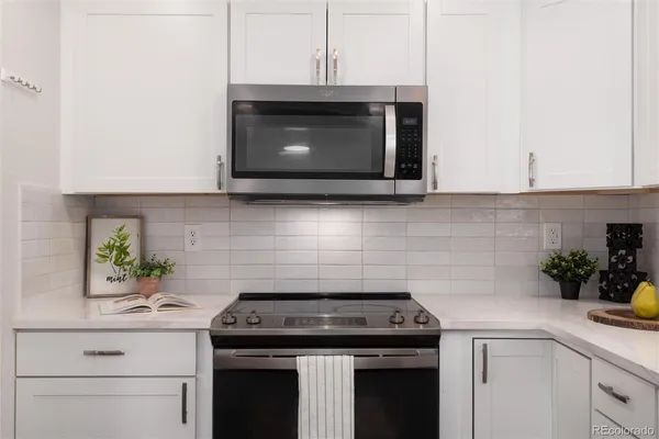 a stove top oven sitting inside of a kitchen