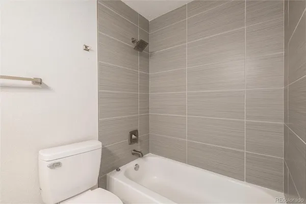 a bath tub sitting next to a white toilet