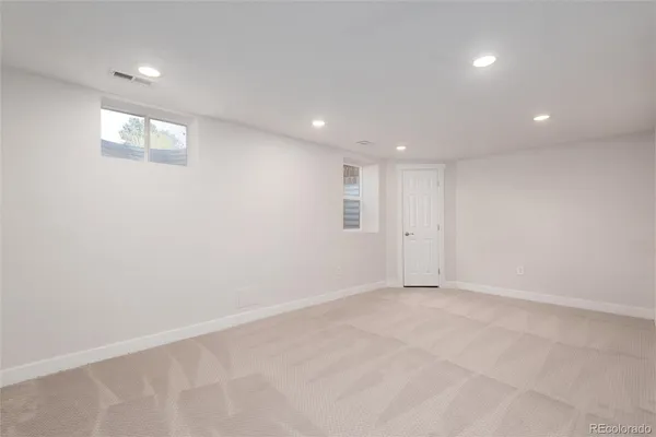 an empty room with windows and entrance