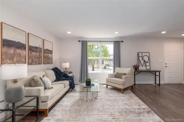 a living room with furniture and a large window