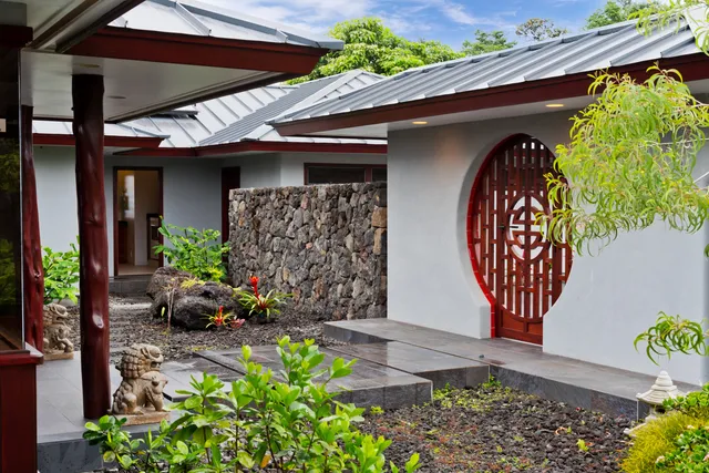 a front view of a house with lots of potted plants