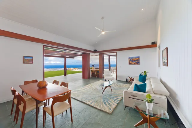 a living room with furniture kitchen view and a table