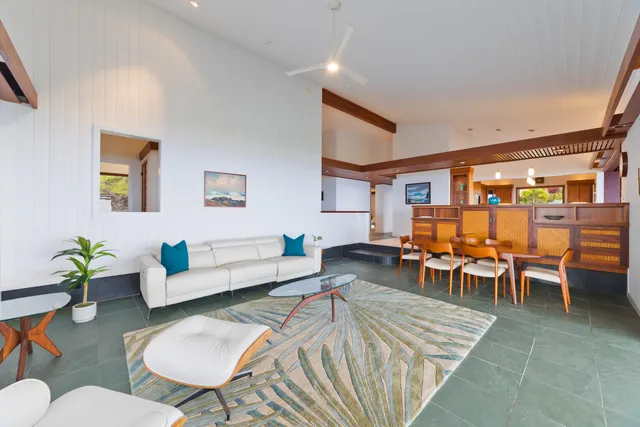 a living room with furniture a table and chairs in it