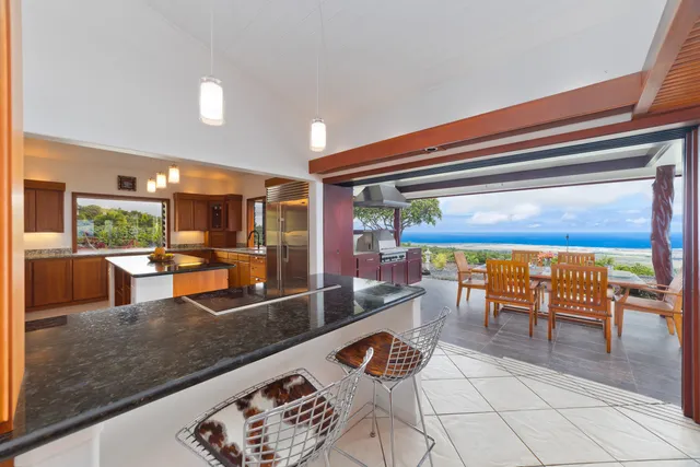 a kitchen with stainless steel appliances granite countertop a sink and a stove