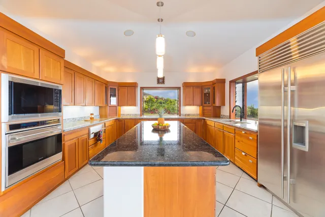 a kitchen with stainless steel appliances granite countertop a sink and stove