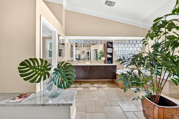 a bathroom with a granite countertop sink a mirror and shower