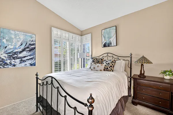 a bed room with a bed and a lamp