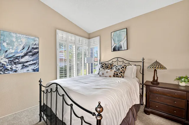 a bed room with a bed and a lamp