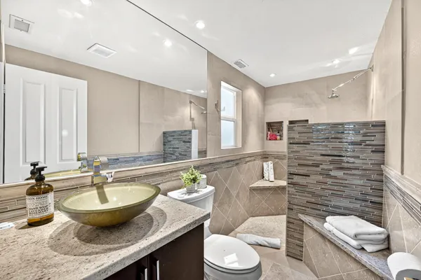 a spacious bedroom with a bed and a potted plant