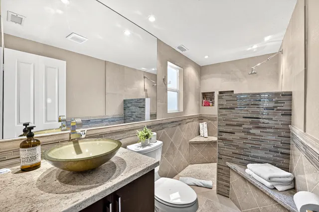 a spacious bedroom with a bed and a potted plant