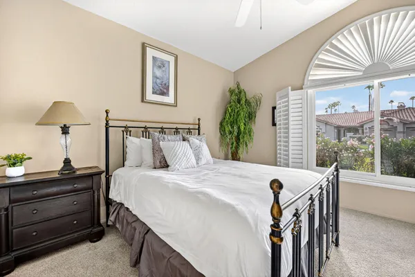 a bedroom with a bed and window