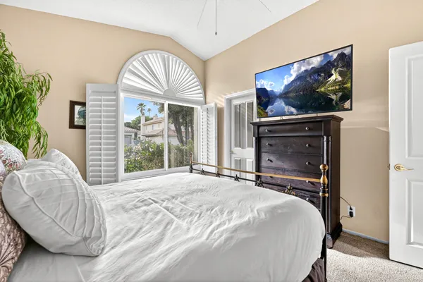 a bedroom with a large bed and a large window