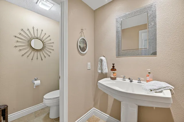 a view of a patio with table and chairs potted plants and palm trees