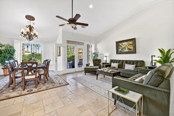 a living room with furniture and painting on the wall