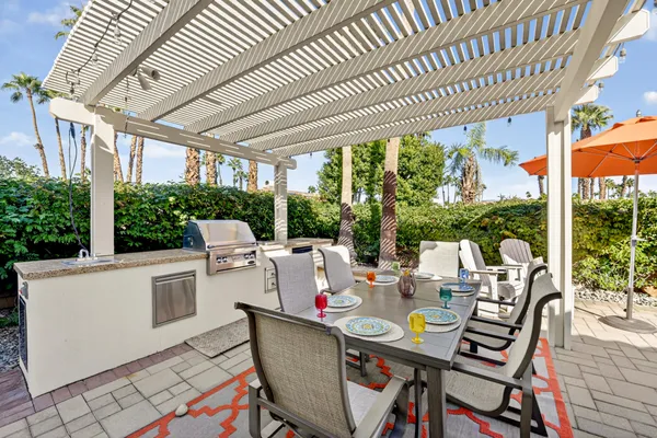 a view of a swimming pool with a table chairs